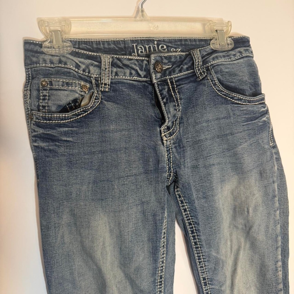 Low rise blue bootcut jeans with white stitching
